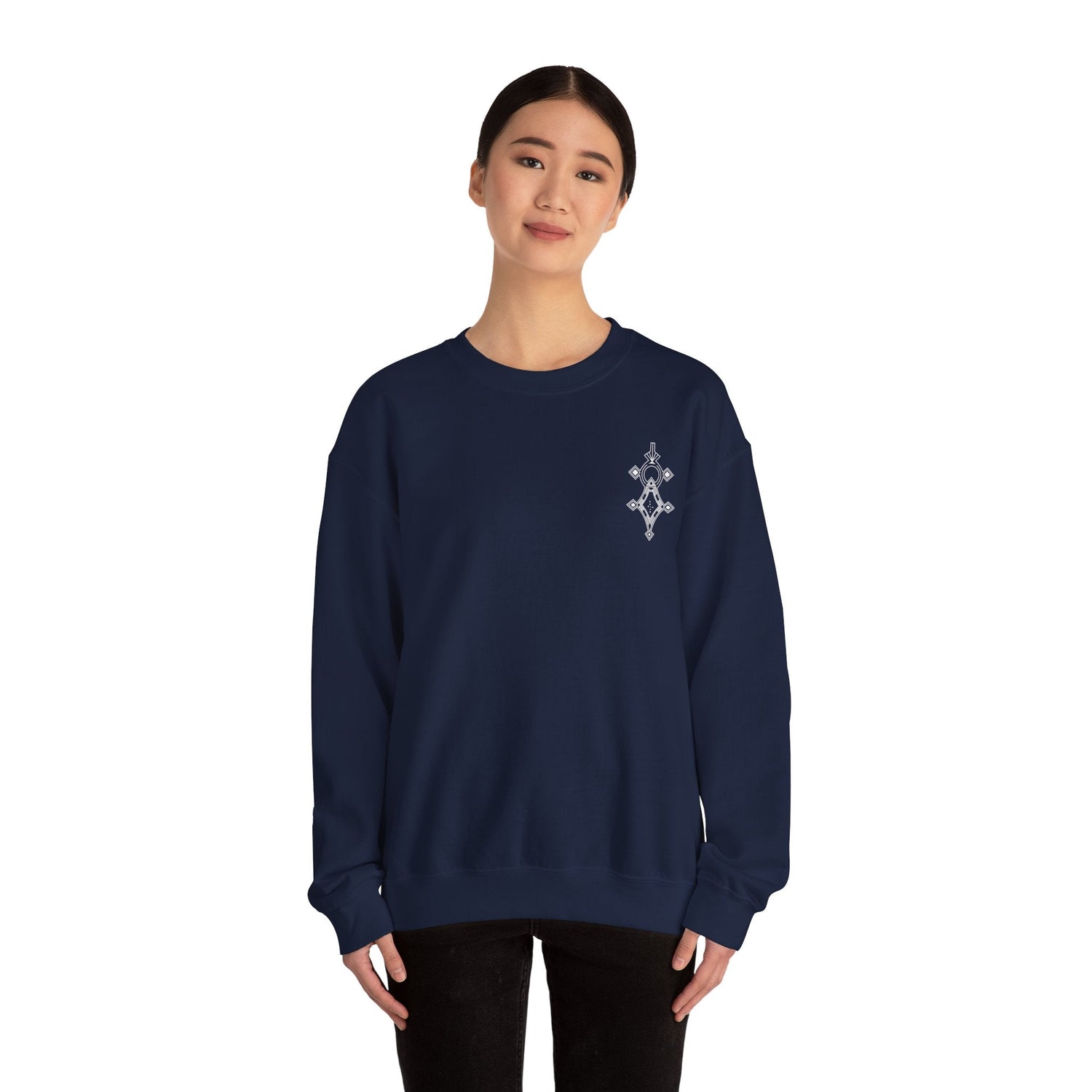 Woman wearing navy blue Heavy Blend™ crewneck sweatshirt with small embroidered design on chest