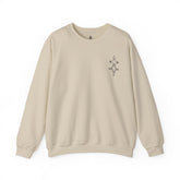 Women Heavy Blend™ Crewneck Sweatshirt in beige with ribbed collar and embroidered design on chest, made from cotton-polyester blend for comfort and durability