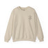 Women Heavy Blend™ Crewneck Sweatshirt in beige with ribbed collar and embroidered design on chest, made from cotton-polyester blend for comfort and durability