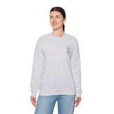 Women Heavy Blend™ crewneck sweatshirt in light grey with long sleeves and embroidered design on chest, made of cotton-polyester blend for comfort and durability