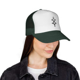 Woman wearing white and dark green trucker cap with black logo and mesh back