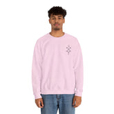 Men wearing light pink Heavy Blend™ Crewneck Sweatshirt with small chest embroidery and blue jeans
