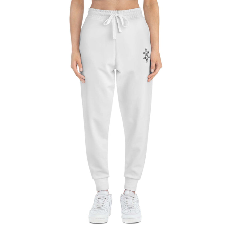 Women athletic joggers in white with drawstring and cuffed ankles, featuring a small side logo.