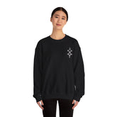 Woman wearing black Heavy Blend™ Crewneck Sweatshirt with embroidered design on chest