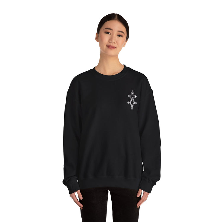 Woman wearing black Heavy Blend™ Crewneck Sweatshirt with embroidered design on chest