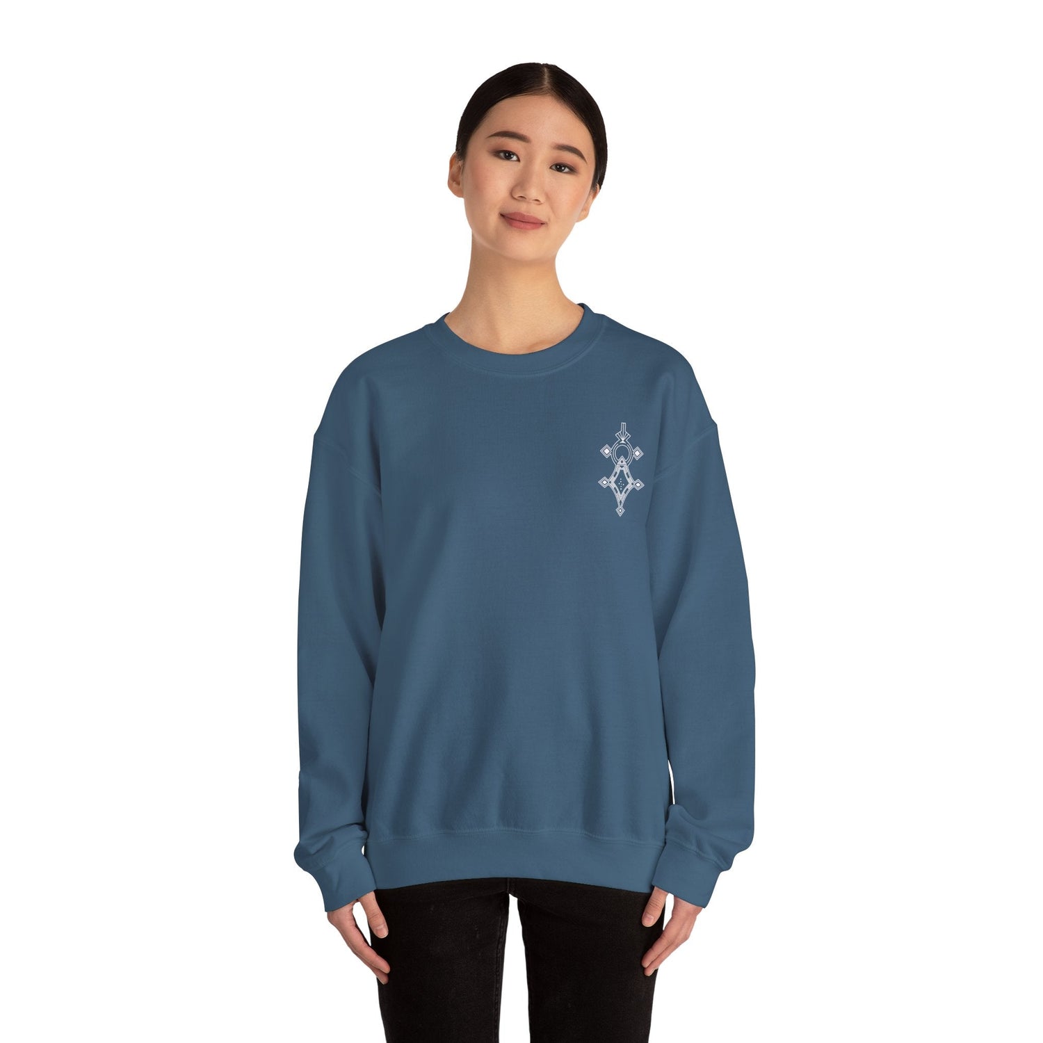 Woman wearing blue Heavy Blend™ Crewneck Sweatshirt with embroidered design on chest