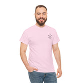 man wearing light pink heavy cotton tee with small geometric design on chest and blue jeans smiling