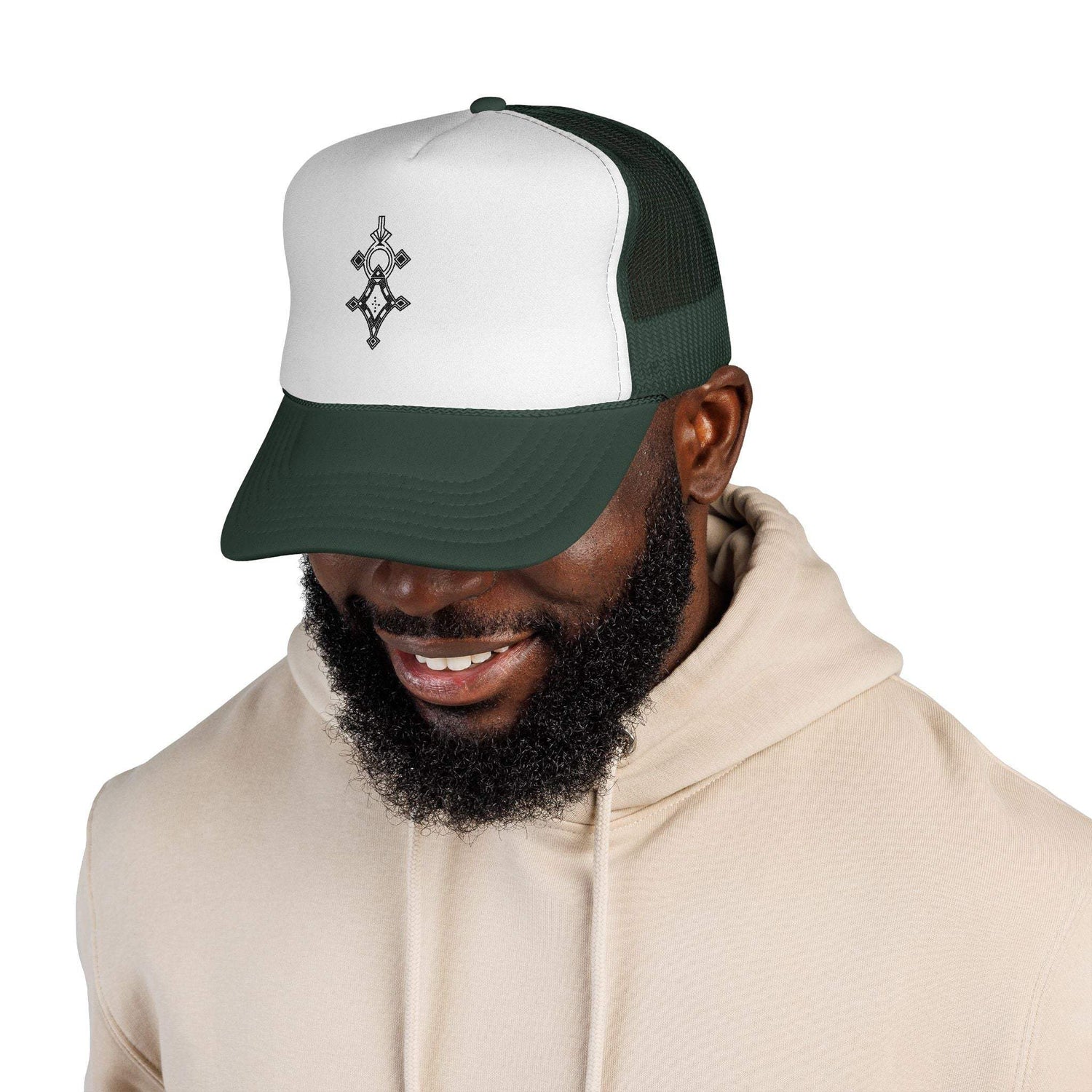 Man wearing white and green trucker cap with adjustable snapback and embroidered front design