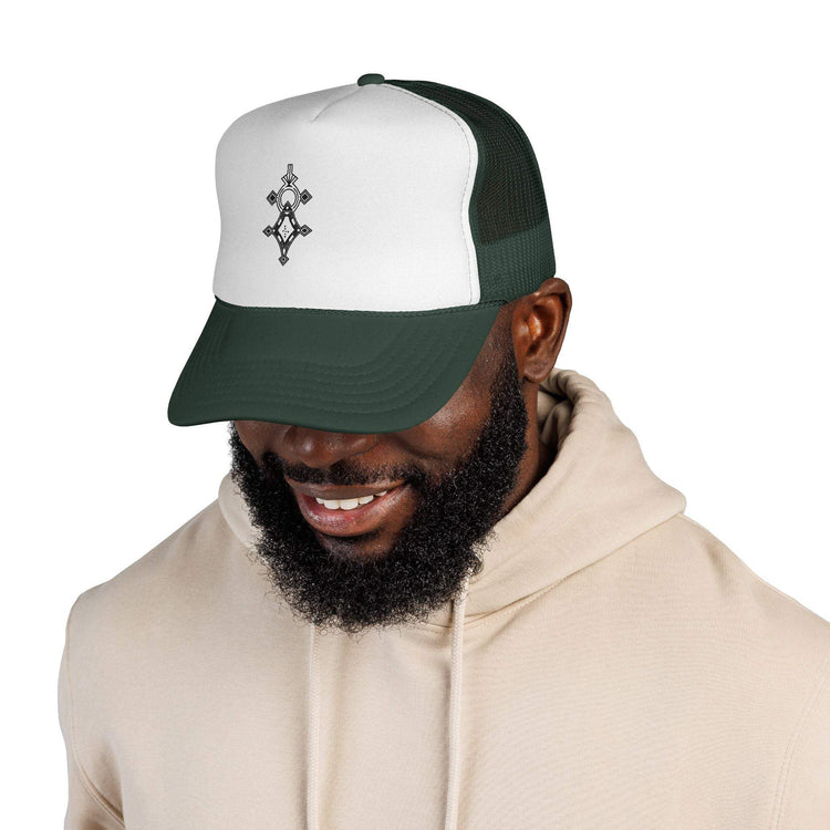 Man wearing white and green trucker cap with adjustable snapback and embroidered front design