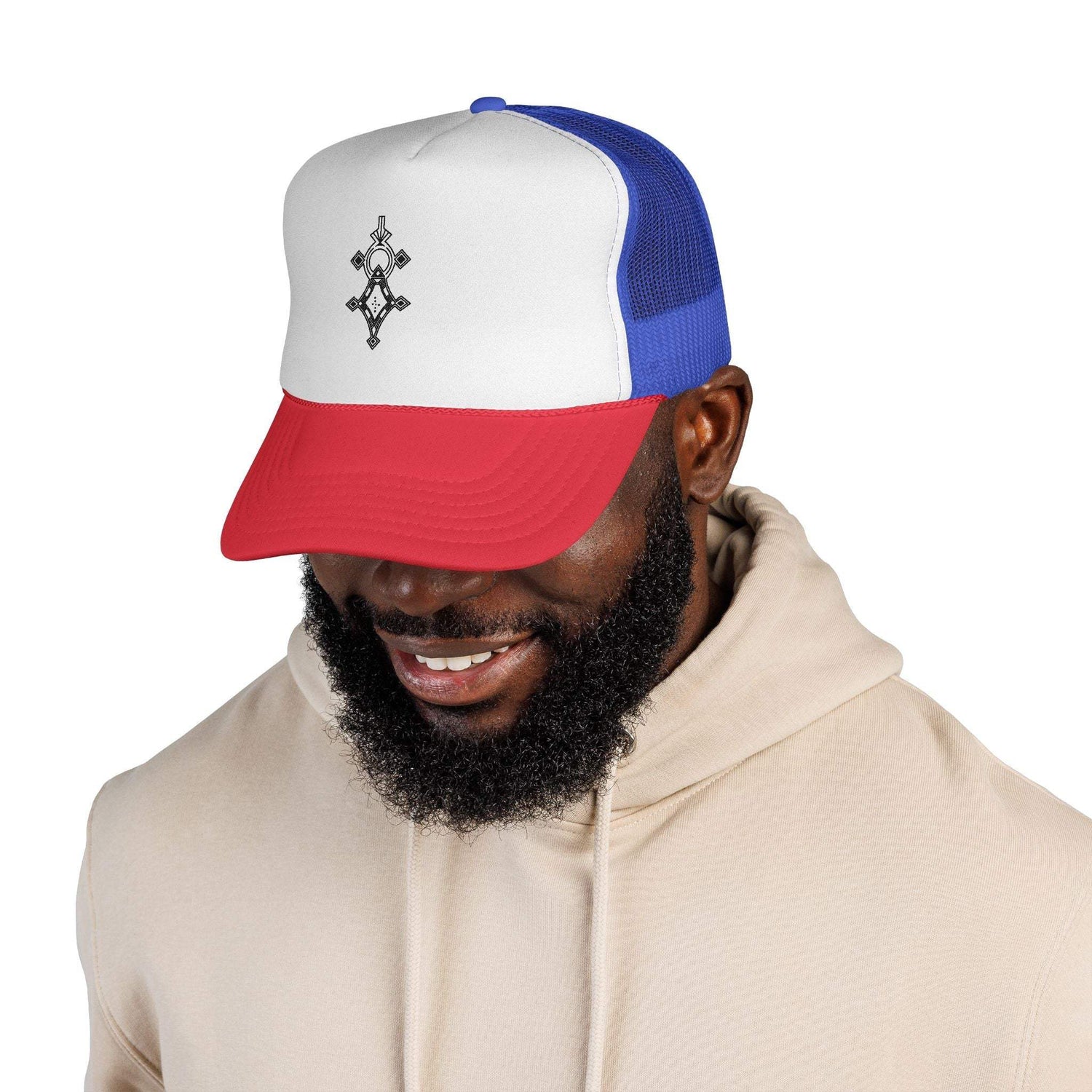 Man wearing a red, white, and blue trucker cap with mesh back and embroidered front design