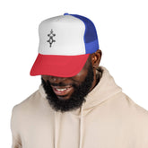 Man wearing a red, white, and blue trucker cap with mesh back and embroidered front design