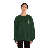 Woman wearing dark green Heavy Blend™ Crewneck Sweatshirt with embroidered design on chest