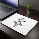 Rectangular mouse pad with white cloth top and geometric black design on office desk next to laptop and small plant