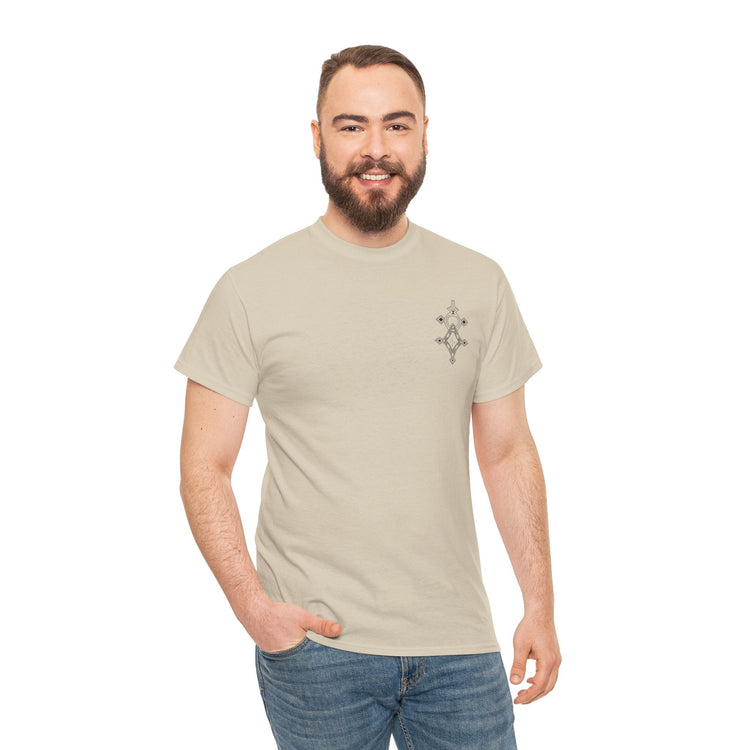 Man wearing beige heavy cotton tee with small chest design and blue jeans smiling against white background