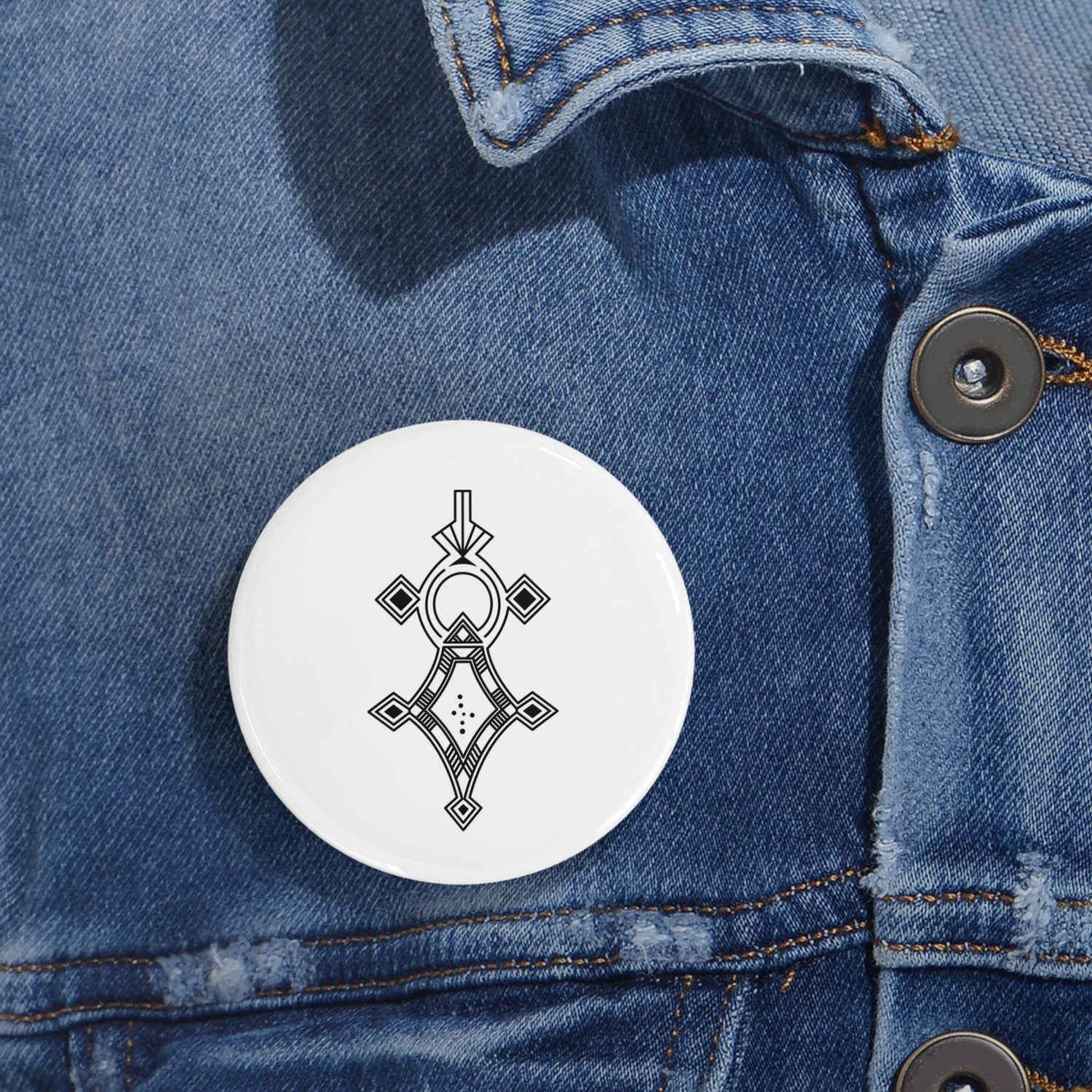 Round pin with geometric design on denim jacket, durable steel and glossy UV cover accessory