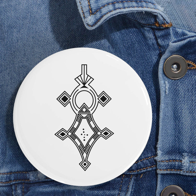 Round pin with black geometric design on white background, pinned to denim jacket, durable steel shell and scratch-resistant glossy finish