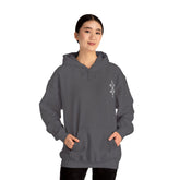 Woman wearing dark gray Heavy Blend™ Hooded Sweatshirt with kangaroo pocket and drawstring hood