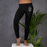 Black polyester spandex leggings with decorative design on thigh, featuring four-way stretch and elastic waistband