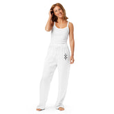 Woman wearing white silky relaxed fit women’s pajama pants with decorative side seam piping and a matching white tank top