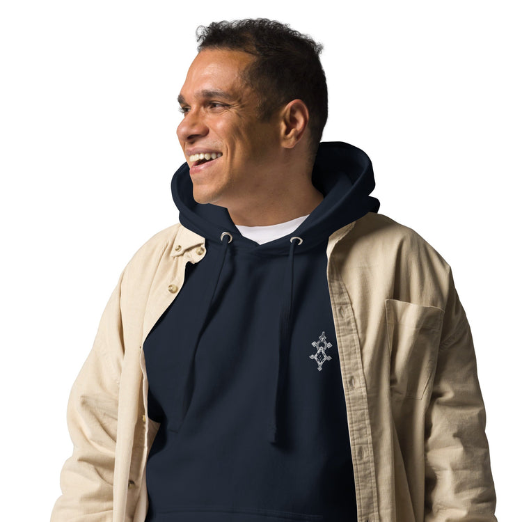 Men wearing navy blue hoodie with front pouch pocket and beige jacket smiling looking sideways