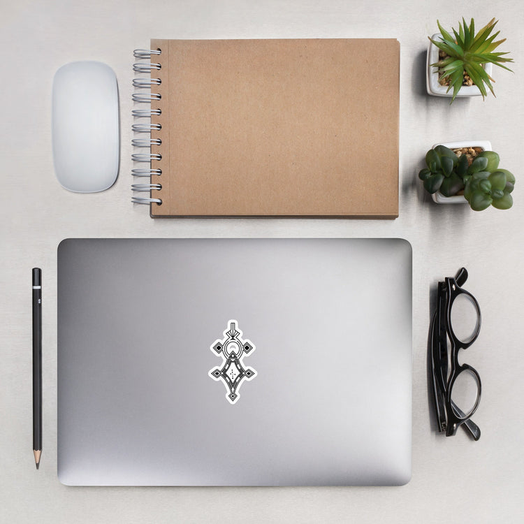 Bubble-free sticker on laptop with notebook, mouse, pencil, glasses, and plants on desk