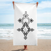 White sublimation towel with black geometric design held on beach background