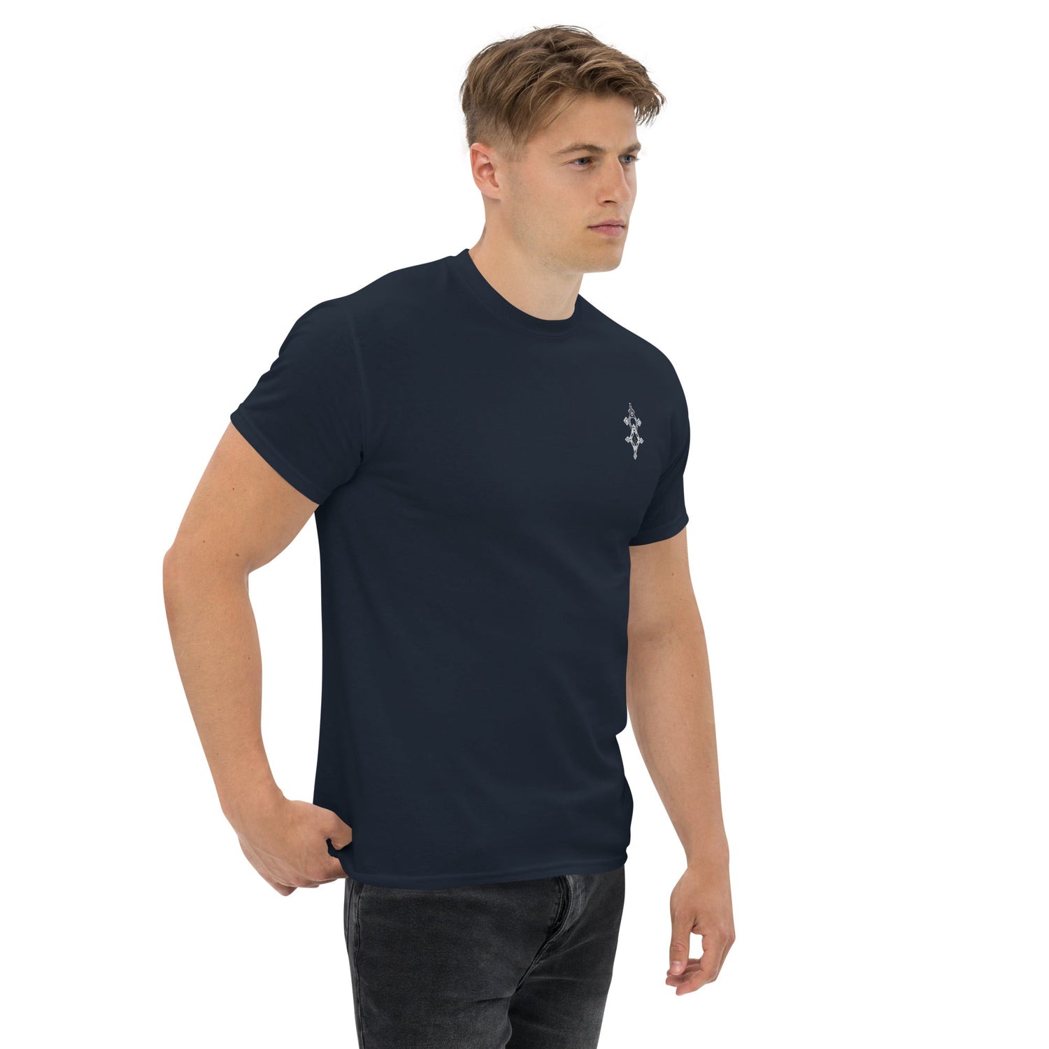 Man wearing navy blue classic tee with small chest design and black jeans