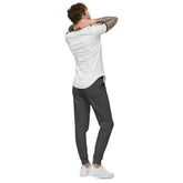 Man wearing charcoal heather men fleece sweatpants with elastic waistband and cuffed legs