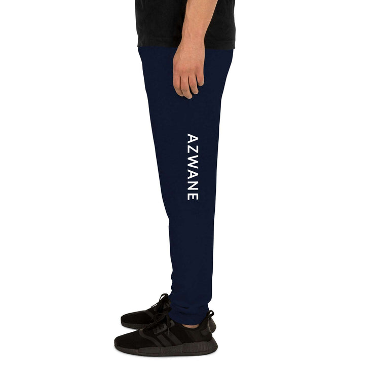 Side view of man wearing navy mens sweatpants with AZWANE text and black sneakers