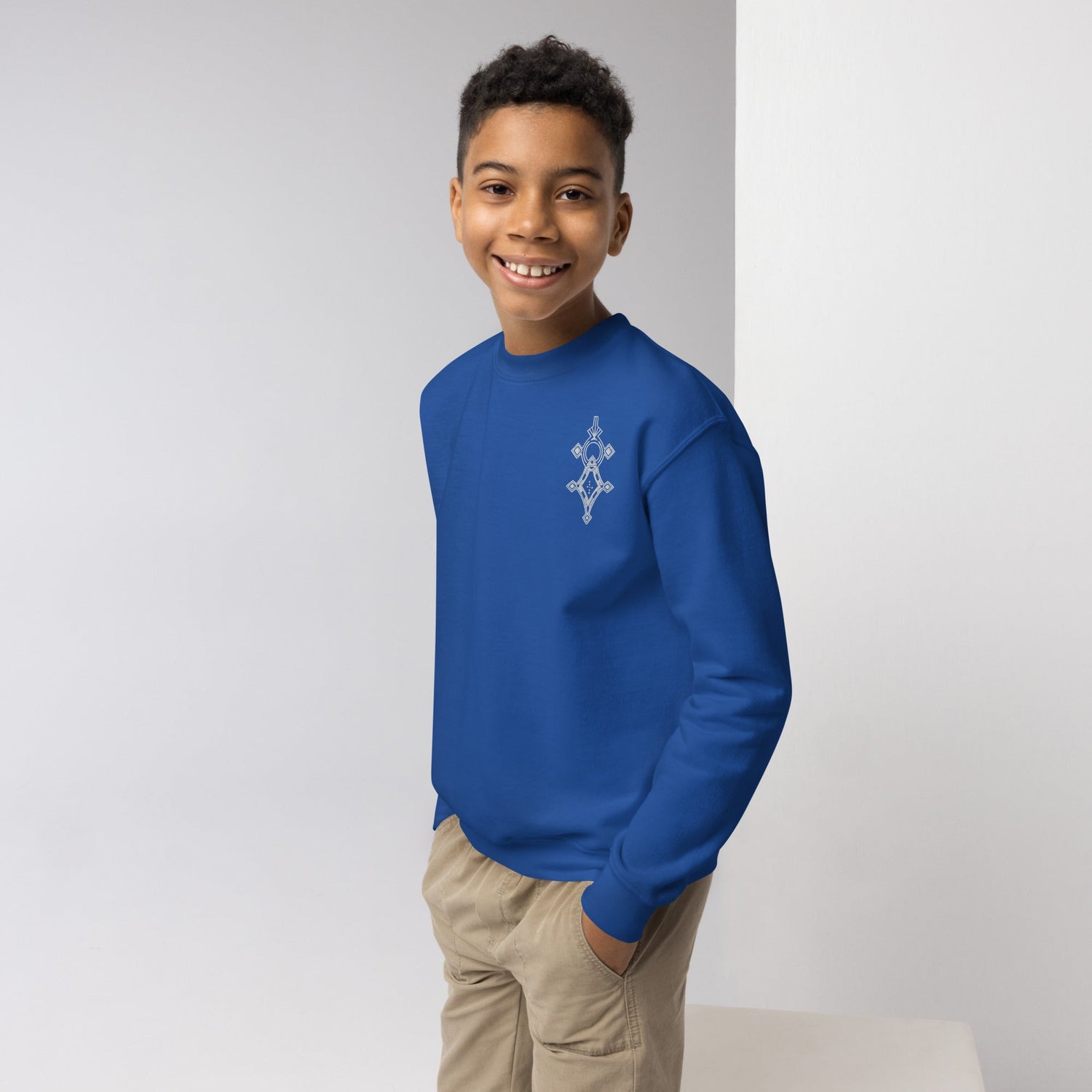 Youth wearing blue cozy fleece youth crewneck sweatshirt with graphic design
