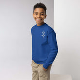 Youth crewneck sweatshirt in blue worn by smiling boy with hands in pockets