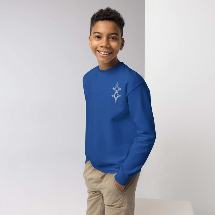 Youth crewneck sweatshirt in blue worn by smiling boy with hands in pockets