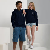 Two children wearing navy youth heavy blend hoodies with front pouch pockets, showcasing comfort and durability.
