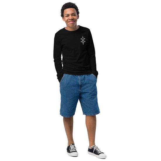 Youth long sleeve tee made of soft Airlume cotton with ribbed cuffs on a smiling boy wearing denim shorts