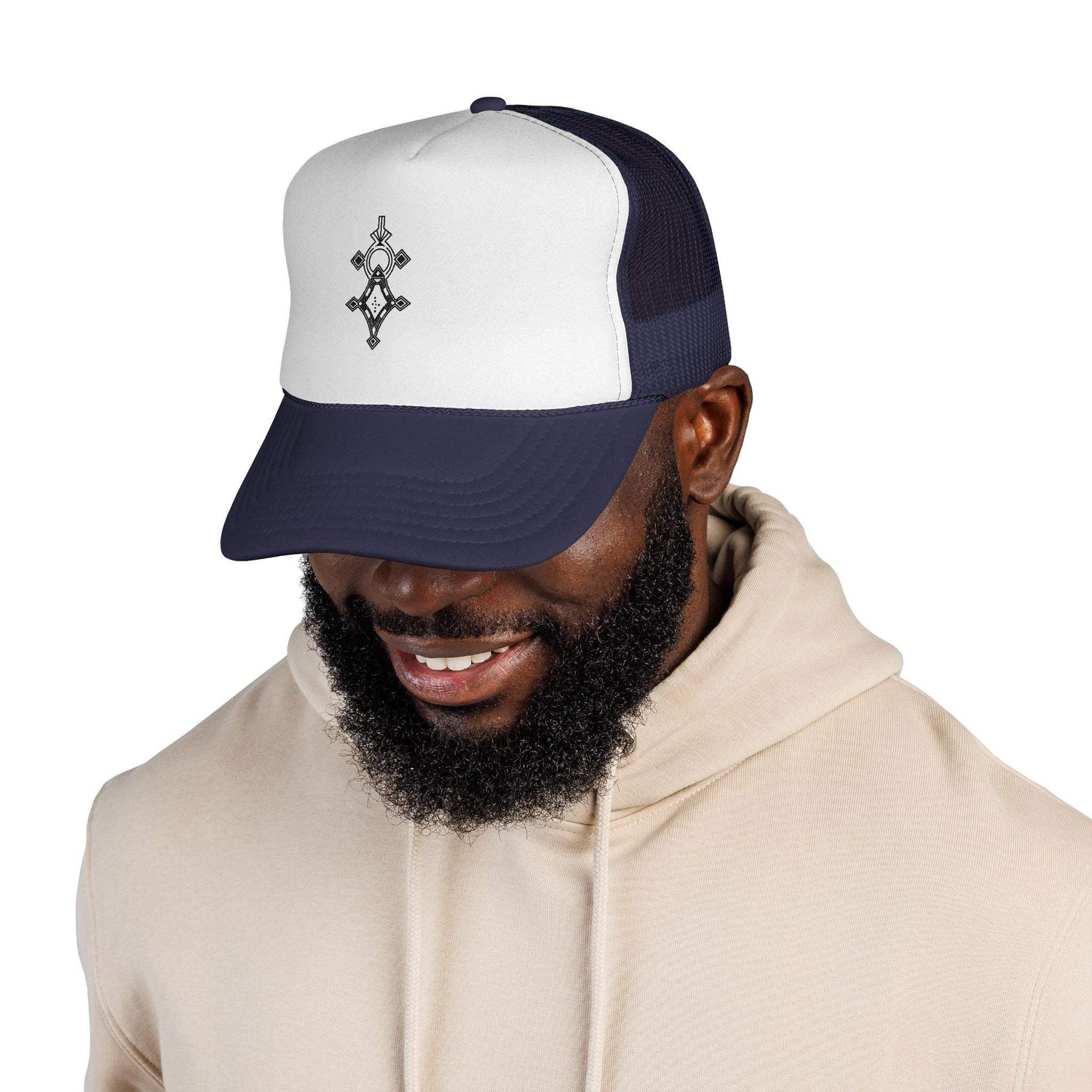 Man wearing a navy and white trucker cap with adjustable snapback and embroidered front logo