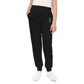 Girls joggers in black with elastic waistband and side pockets, made of 95% recycled polyester and 5% spandex for comfort and style
