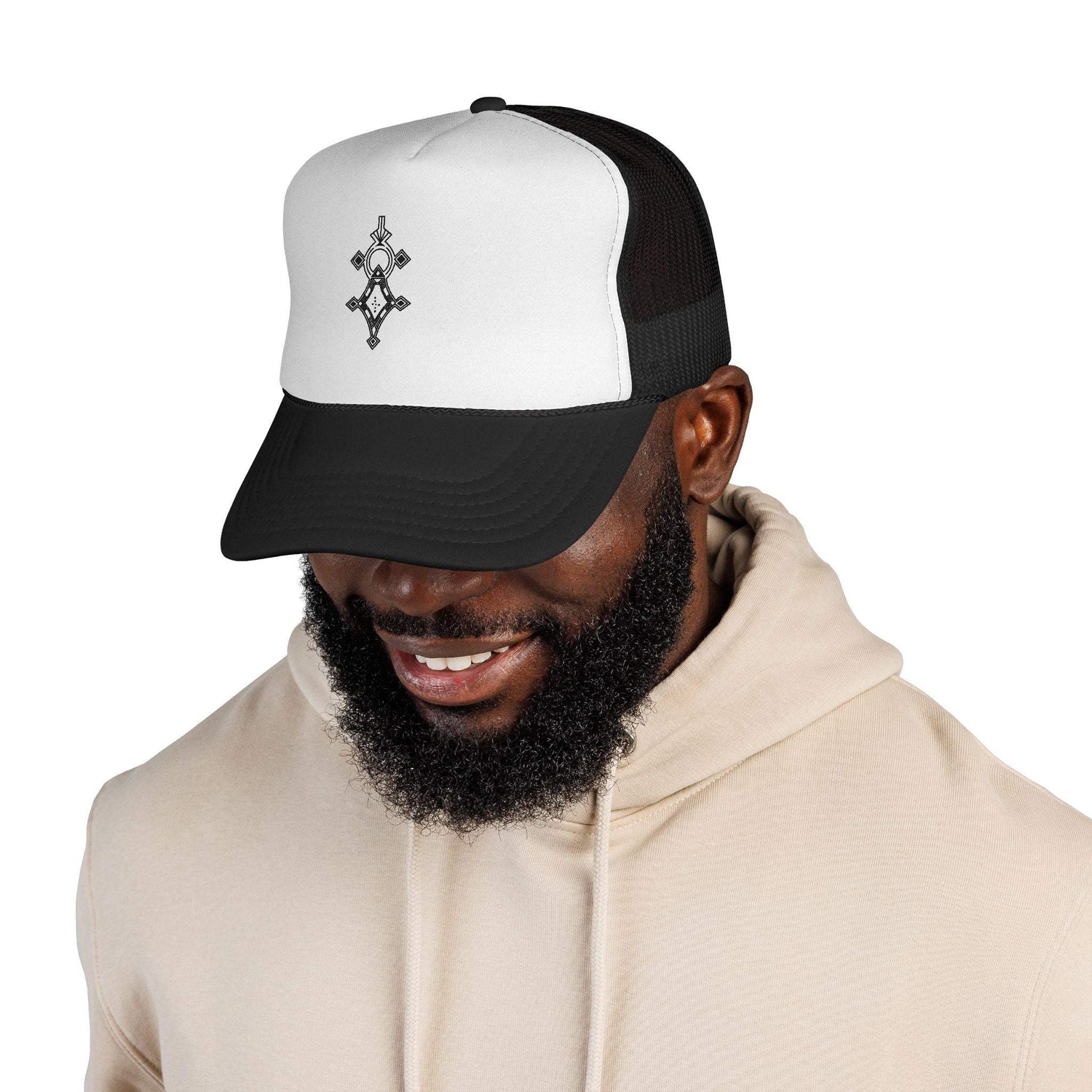 Black and white trucker cap with mesh back and adjustable snap closure worn by a smiling man