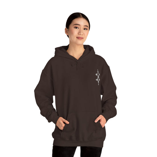 Woman wearing dark brown Heavy Blend™ Hooded Sweatshirt with kangaroo pocket and subtle chest embroidery