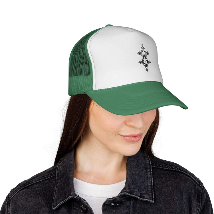 Green and white trucker cap with adjustable snapback and mesh back worn by woman
