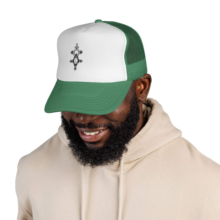 Man wearing green and white trucker cap with adjustable snapback and mesh back