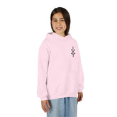 Girl wearing light pink heavy blend hooded sweatshirt with front kangaroo pocket and embroidery on chest