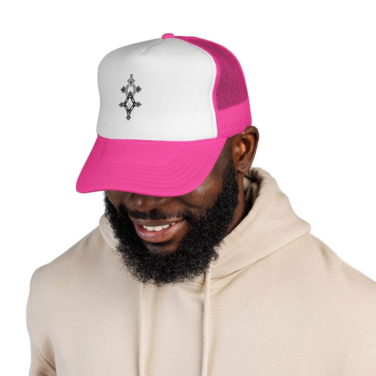 Man wearing pink and white trucker cap with black emblem on front and beige hoodie