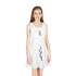 Girl wearing a white sleeveless sundress with black geometric designs, mid-length A-line cut, round neckline