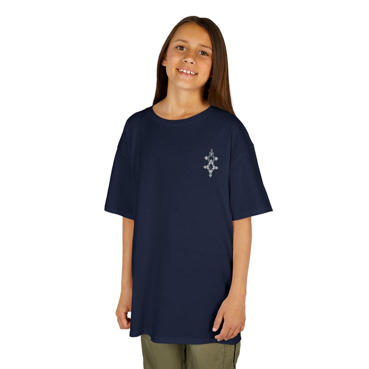 Girl wearing navy Girls Heavy Cotton™ Tee with small white printed design on chest, standing and smiling