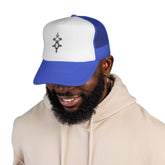 Blue and white trucker cap with adjustable snap closure and six-row visor stitching worn by smiling man
