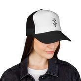 Black and white trucker cap with mesh back and adjustable snap closure worn by woman