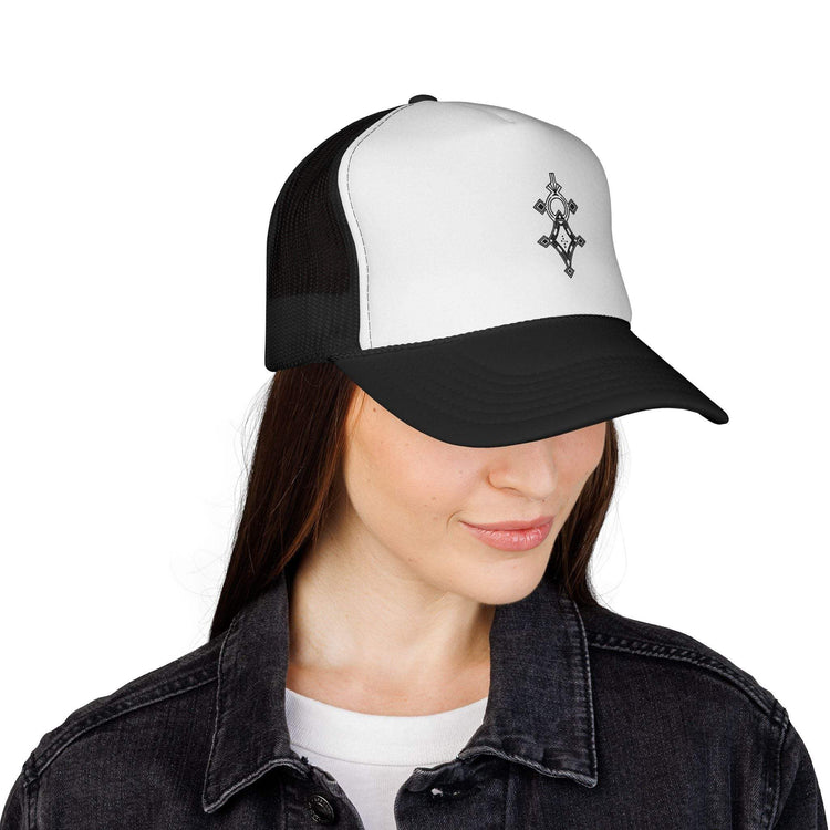 Black and white trucker cap with mesh back and adjustable snap closure worn by woman