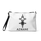 White faux leather crossbody bag with black geometric design, removable wrist strap, and zip-top closure.