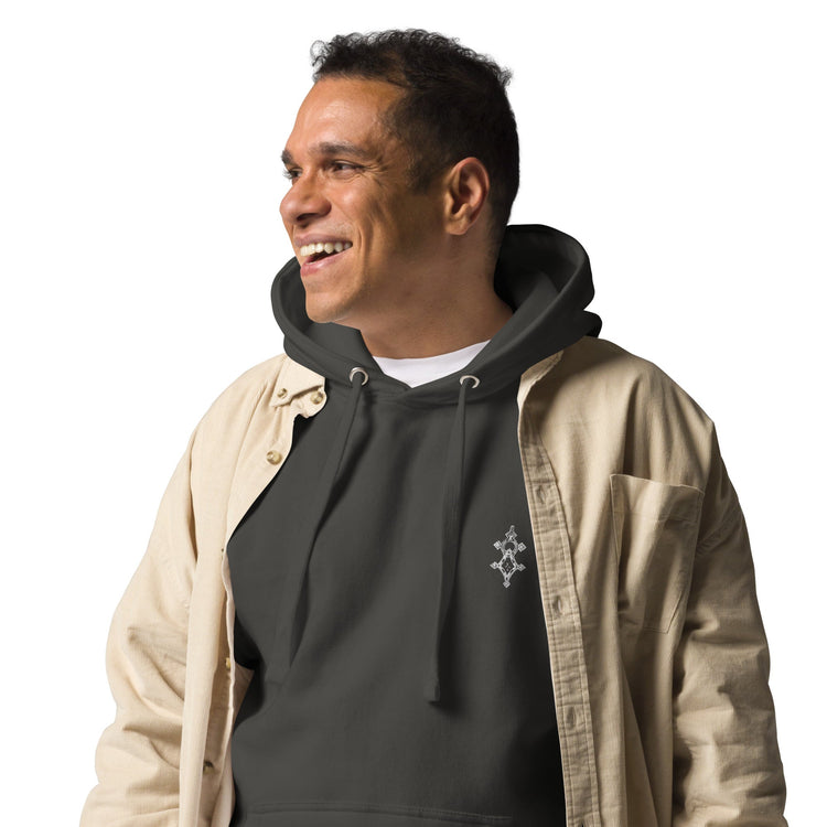 smiling man wearing black men hoodie with front pouch pocket and drawstrings layered under beige shirt