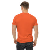 Back view of man wearing orange classic tee made of 100% cotton, paired with black jeans